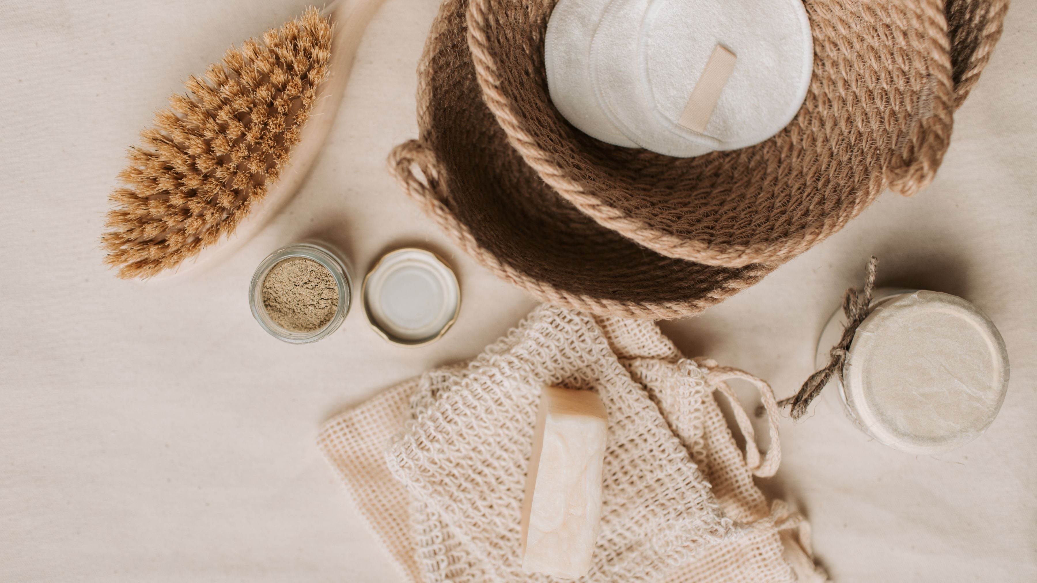 Natural bath essentials including reusable cotton rounds, soap bars, and scrub brushes—zero waste self-care products that complement ecoHiny’s sustainable lifestyle