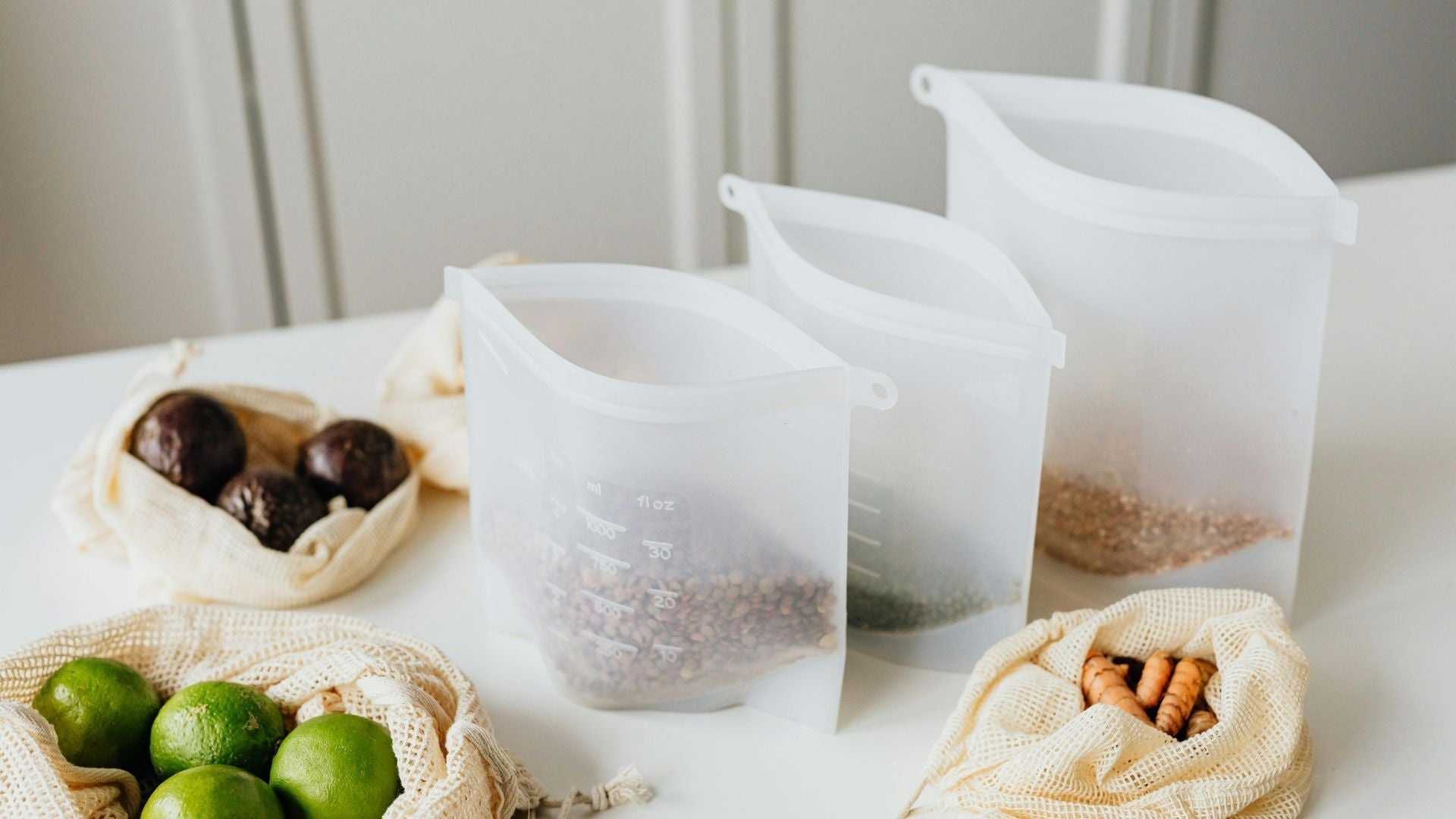 Zero-waste kitchen setup with reusable silicone food storage bags and mesh produce sacks—perfect sustainable living pairings with ecoHiny products