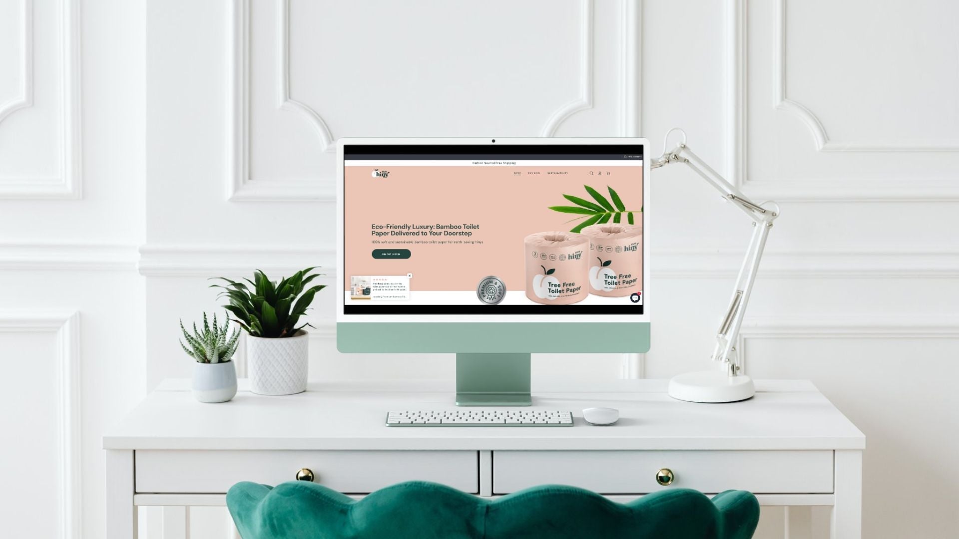 Eco-friendly bamboo toilet paper website displayed on modern home office desktop, showcasing ecoHiny's sustainable packaging and green living aesthetic