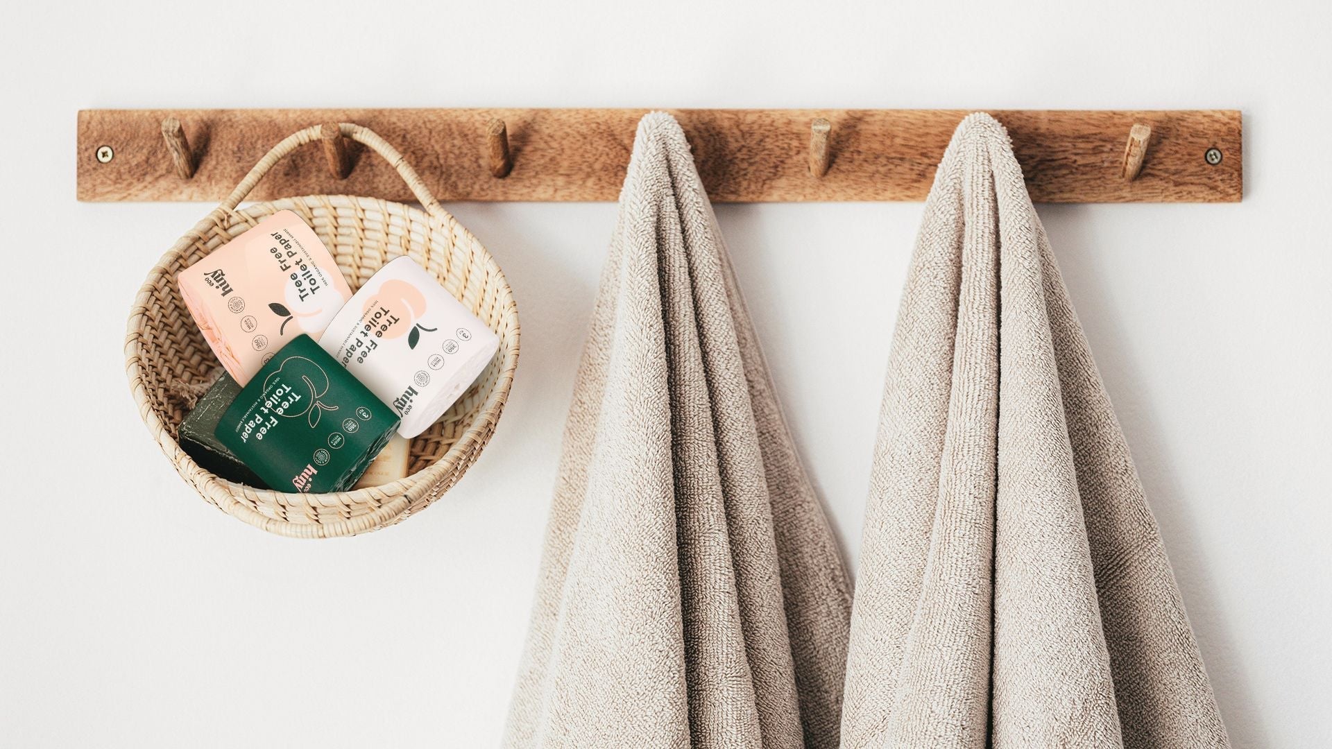 "ecoHiny bamboo toilet paper rolls in a woven basket on a wooden hook—stylish, sustainable bathroom storage with tree-free essentials "