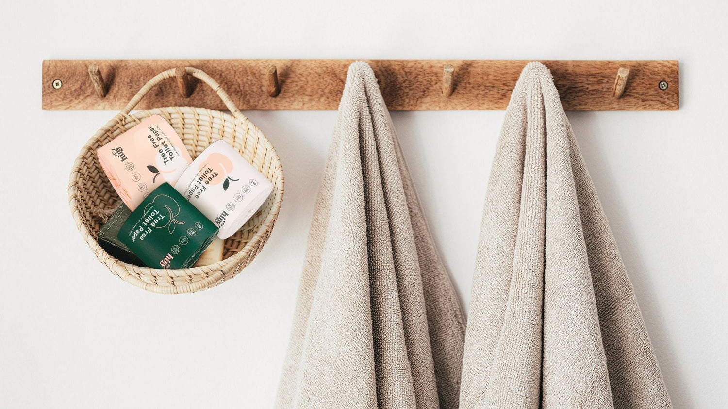 "ecoHiny bamboo toilet paper rolls in a woven basket on a wooden hook—stylish, sustainable bathroom storage with tree-free essentials "