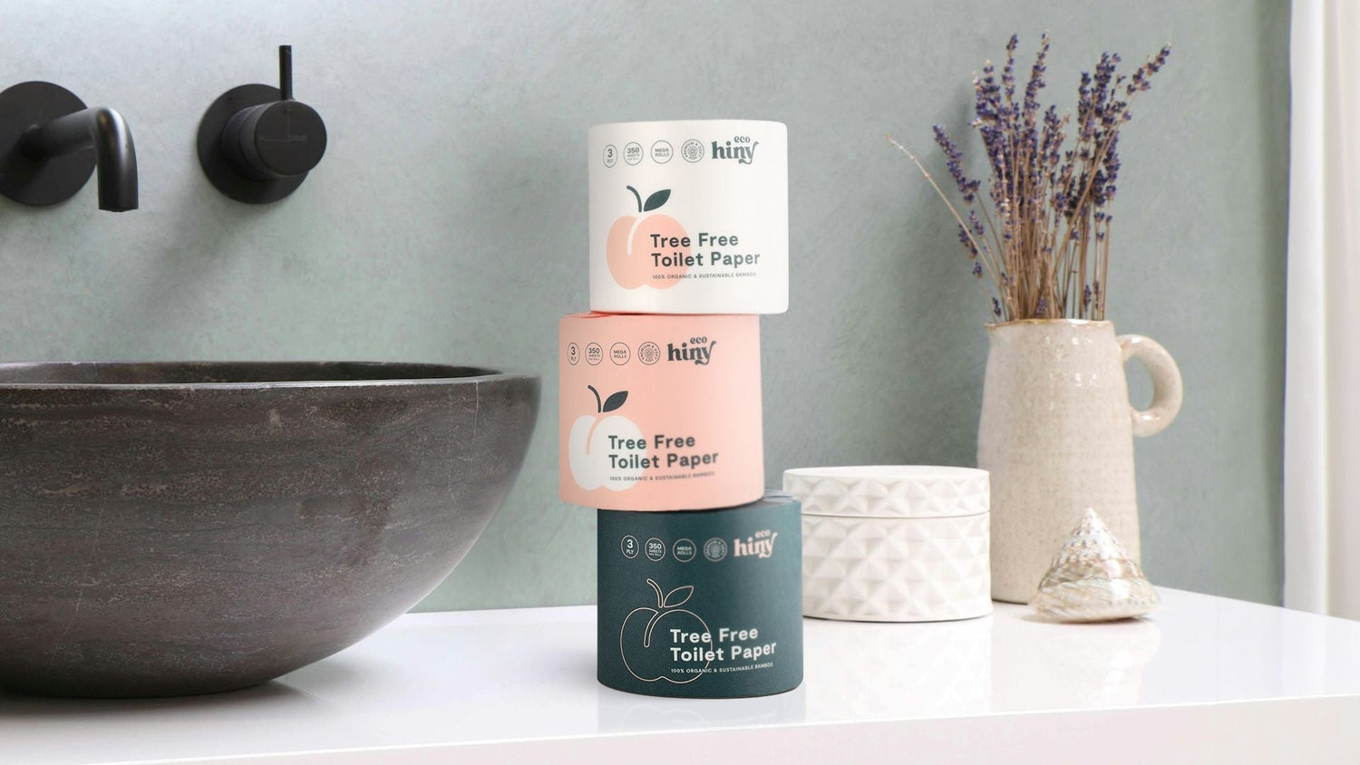 Comparison of top toilet paper brands, with ecoHiny bamboo rolls front and center as the best eco-friendly, tree-free option